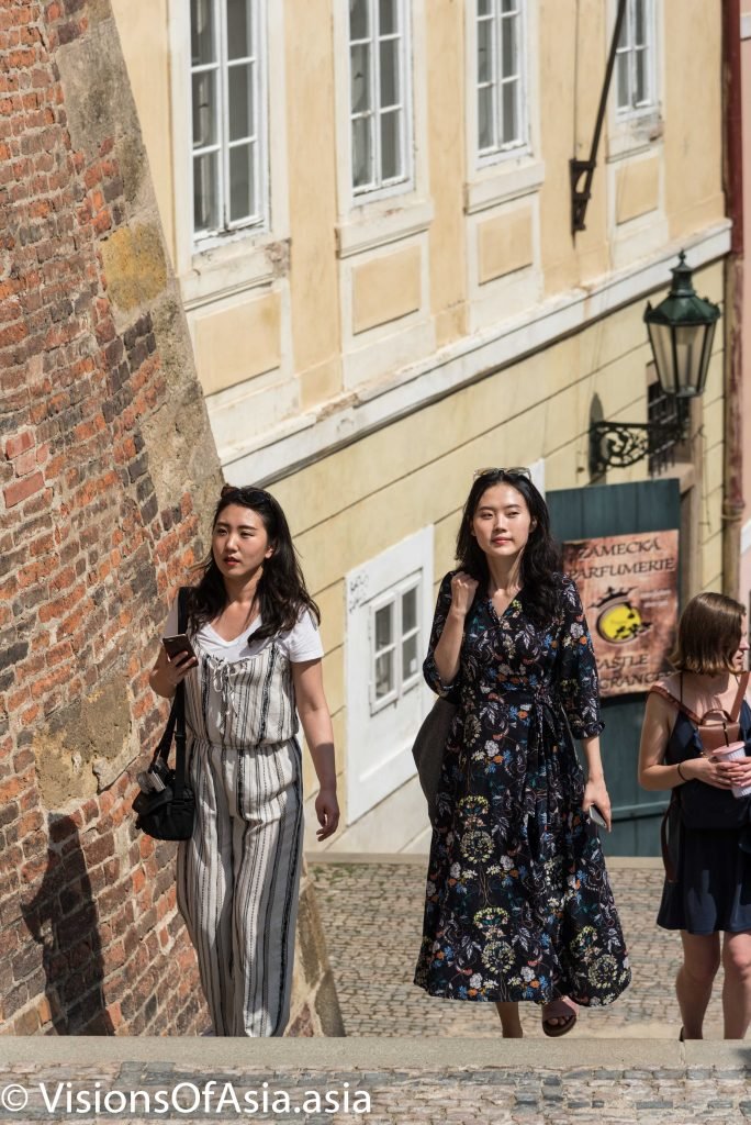 Chinese tourists climbing stairs to Prague castle