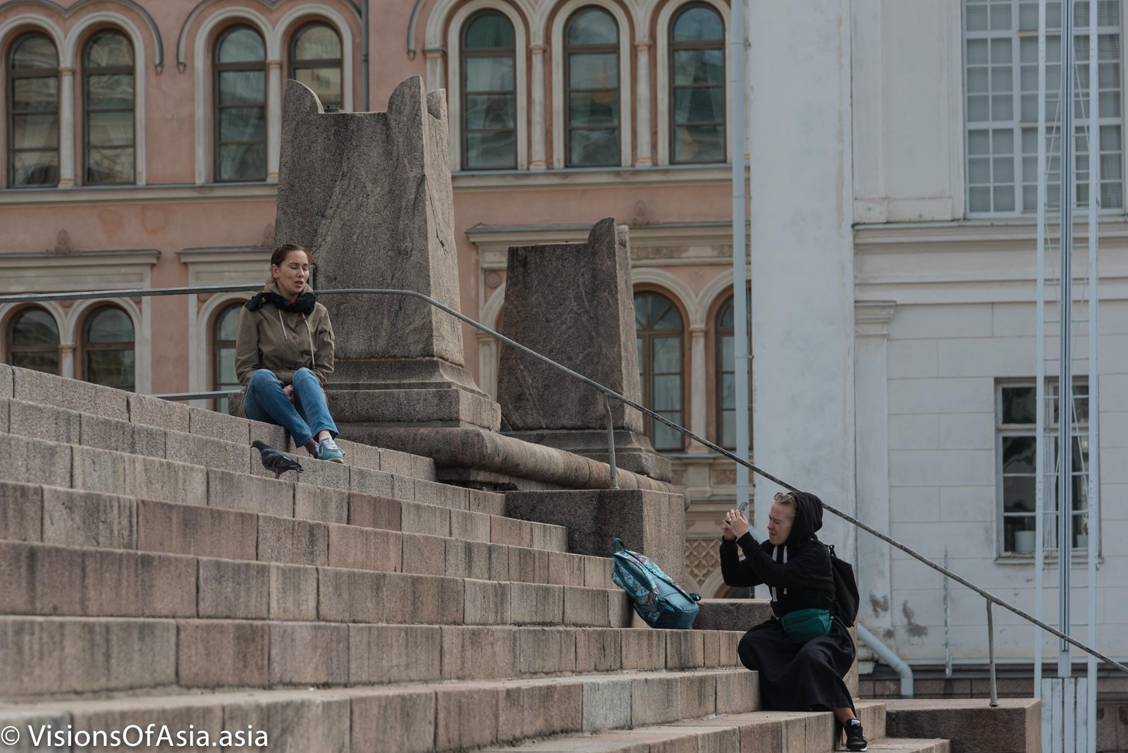 Girl has picture taken on stairs of Tuomiokirkko