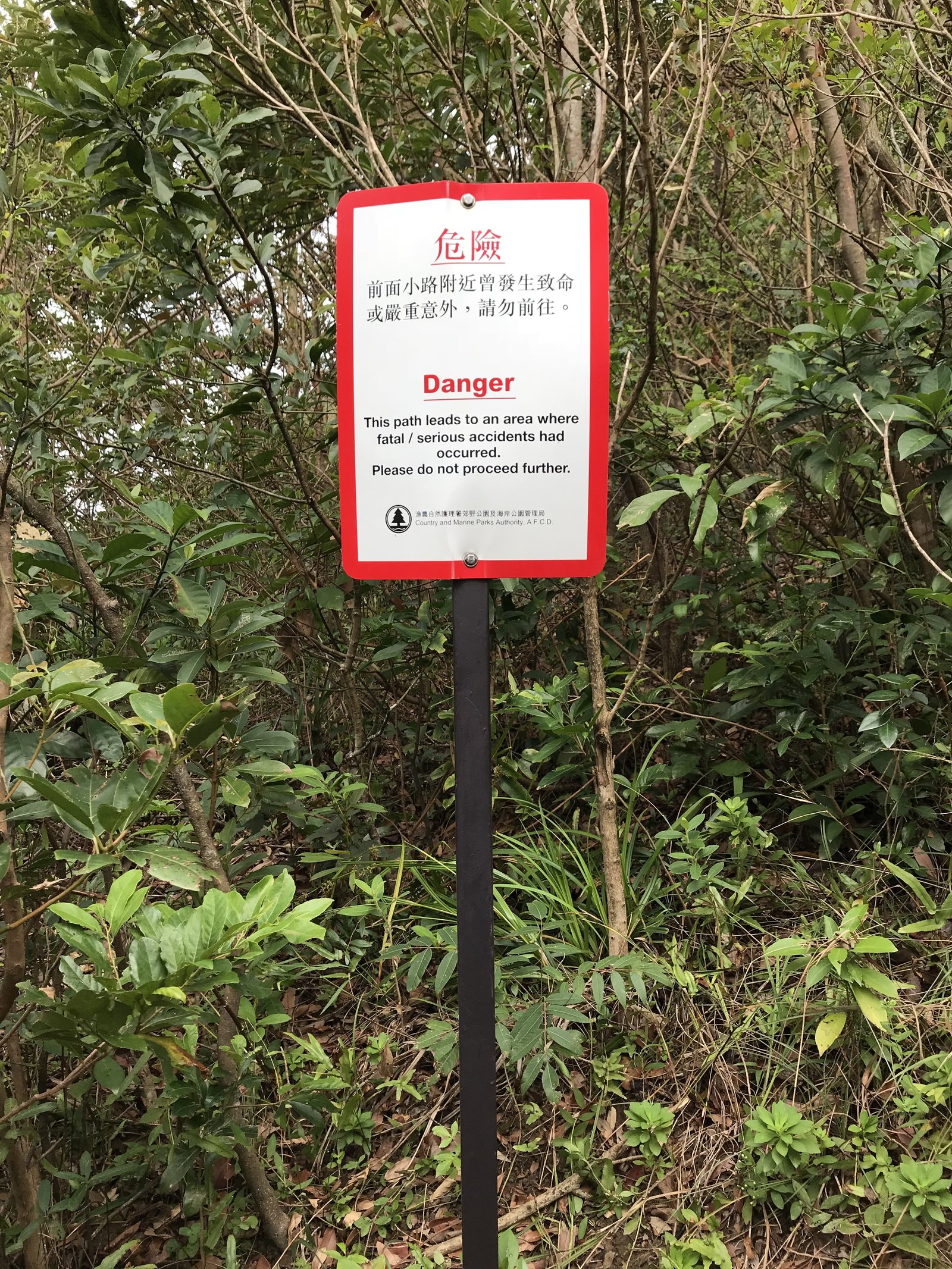 warning board on suicide cliff route