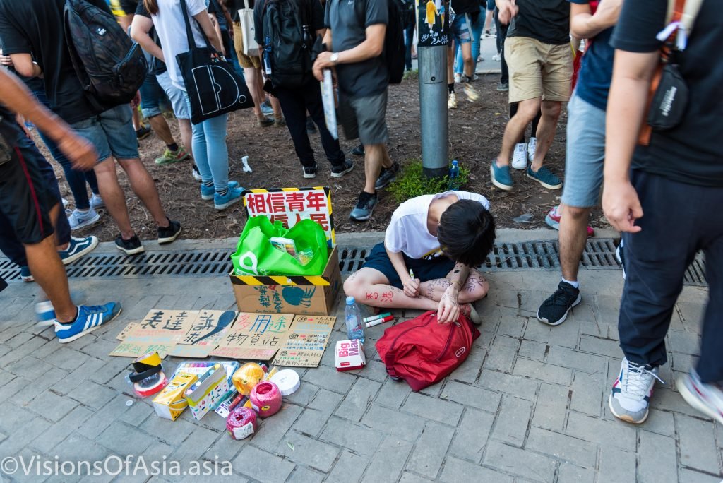 A girl writes slogans on her limbs