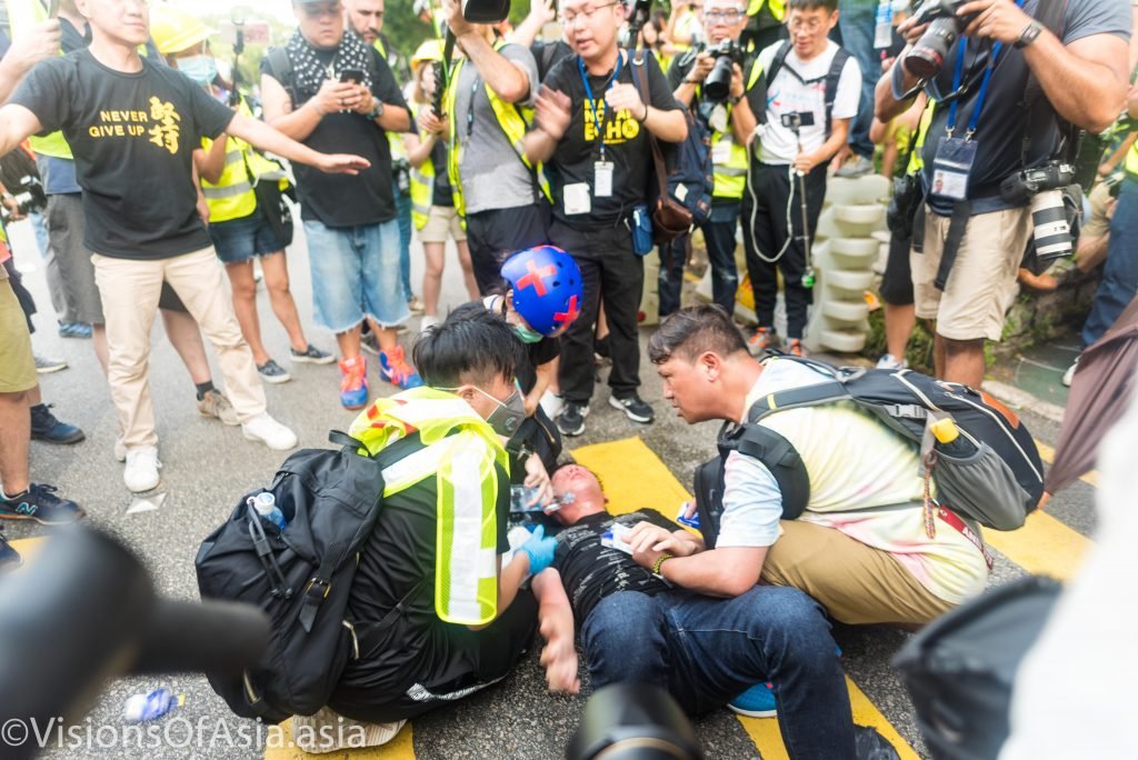An injured protester is treated