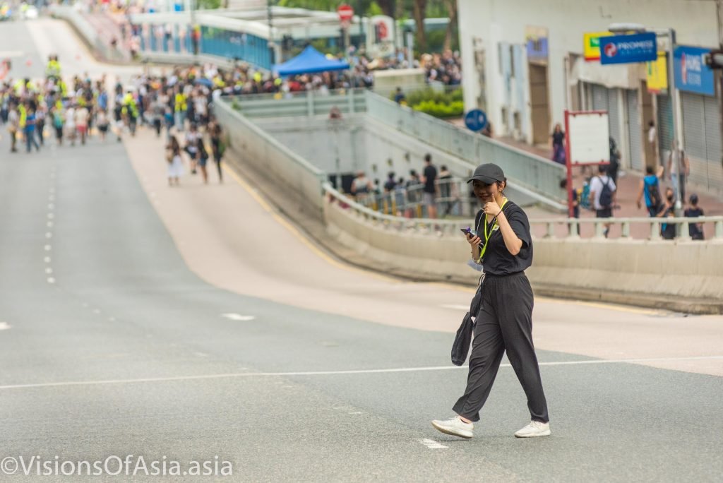 A protester gives a thumbs-up to the camera