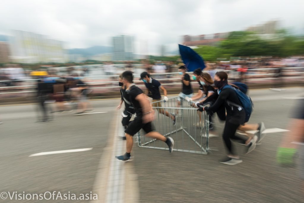 Protesters dragging barricades