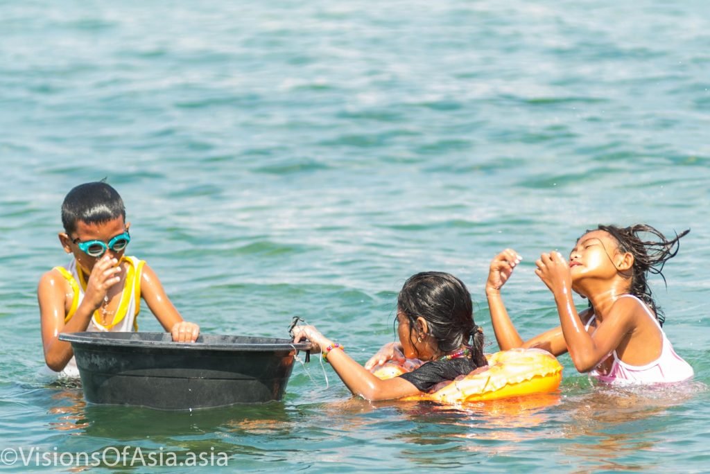 Children fishing sea urchins