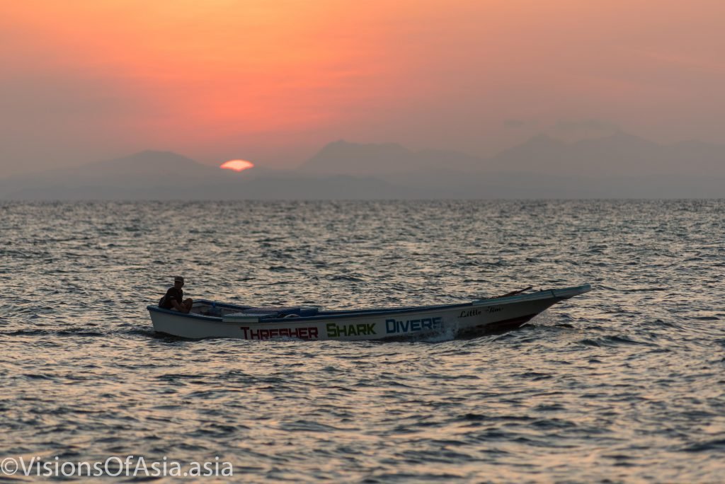 Boat before rising sun