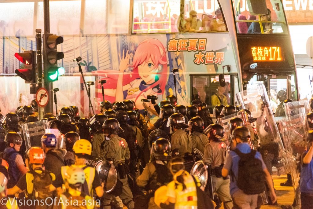 Riot police and bus passengers.