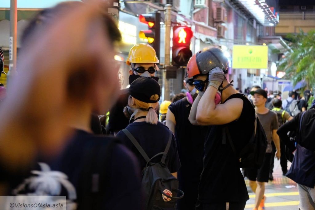 A protesters wears his helmet