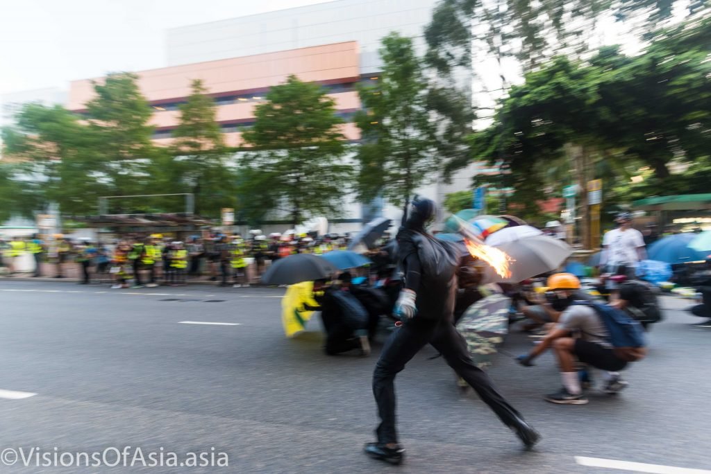 A protester throws a molotov cocktail