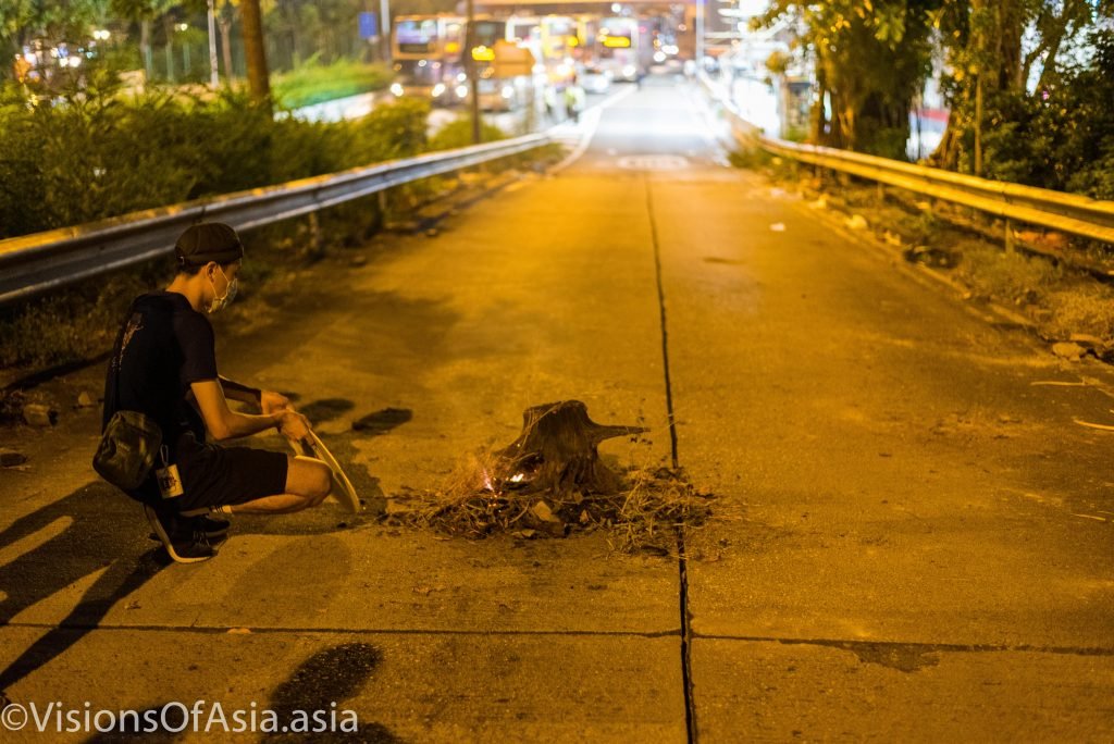 A protester moves embers