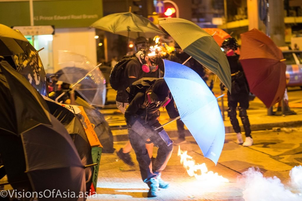 A protester sets alight his own hair