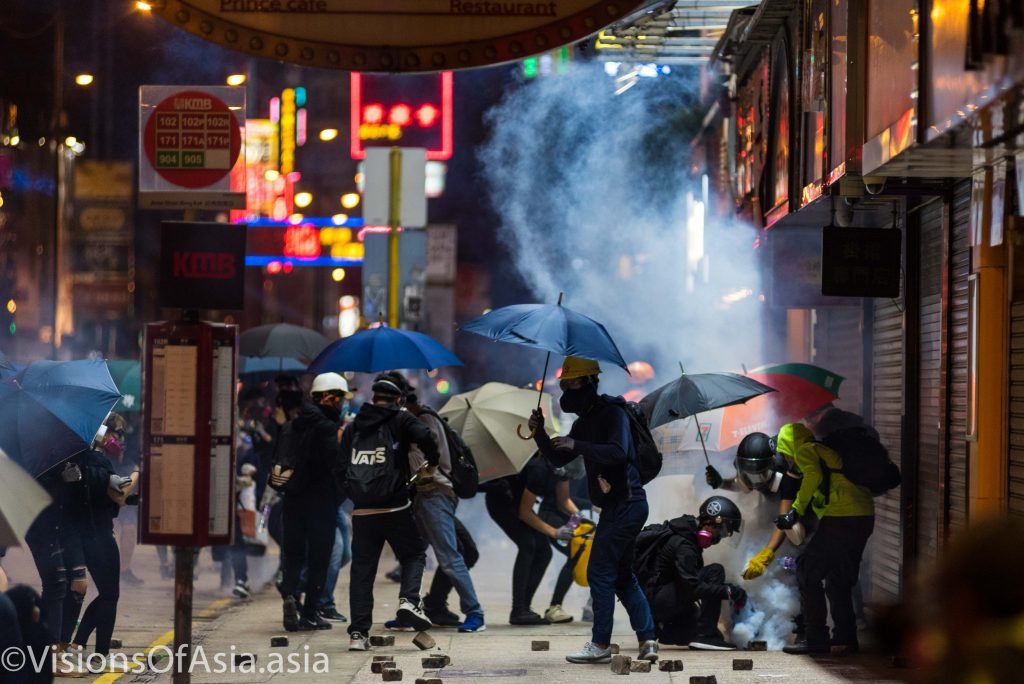 Protesters neutralize tear gas canisters in Mongkok