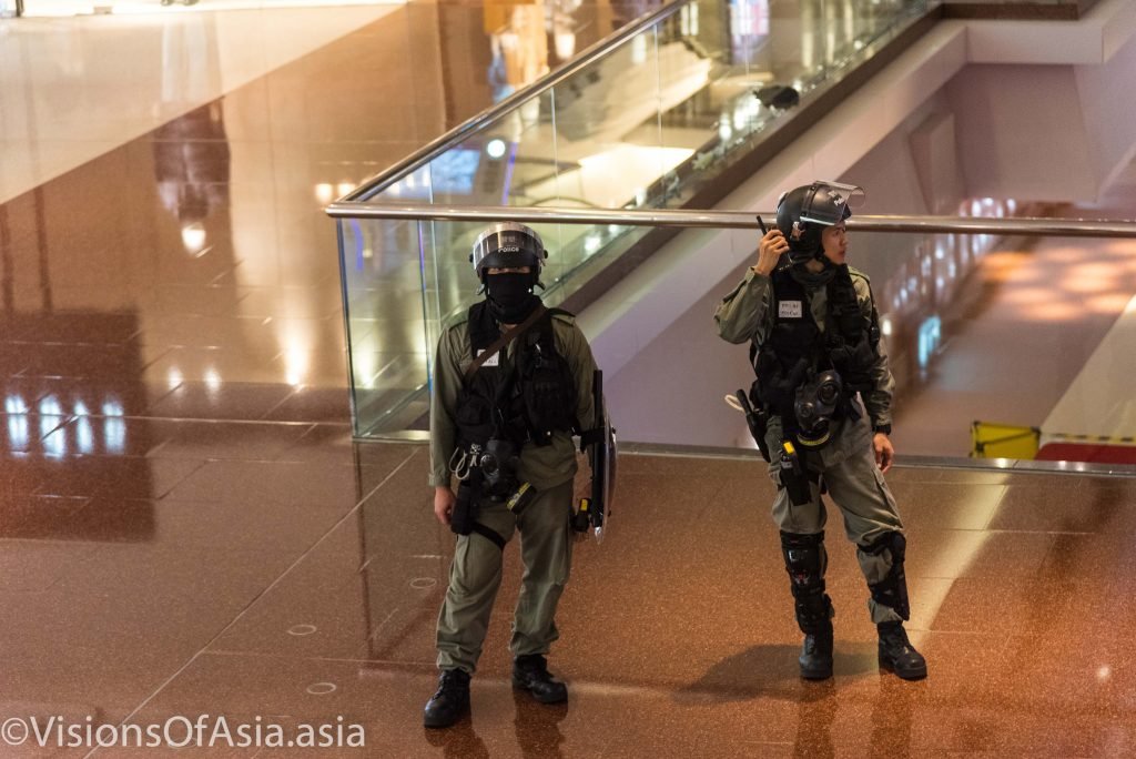 Police stand guard as they pushed back journalists out of the mall