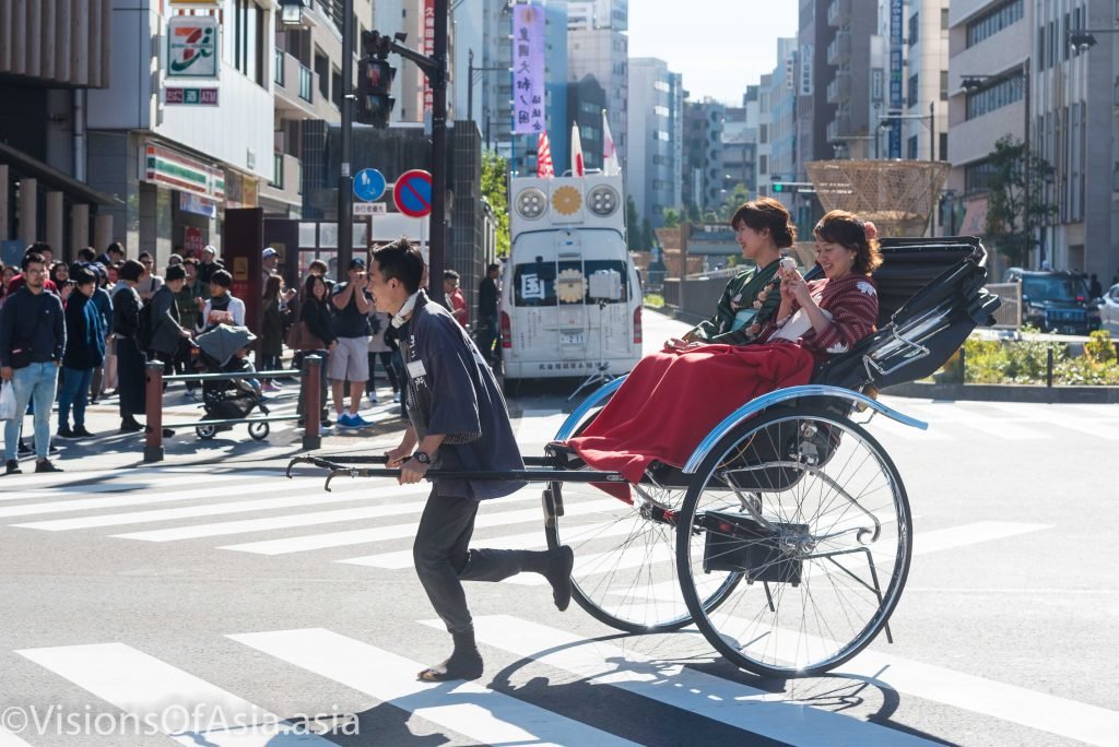 Tourists ride in a rickshaw