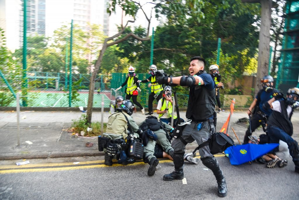 A policeman warns protesters not to advance