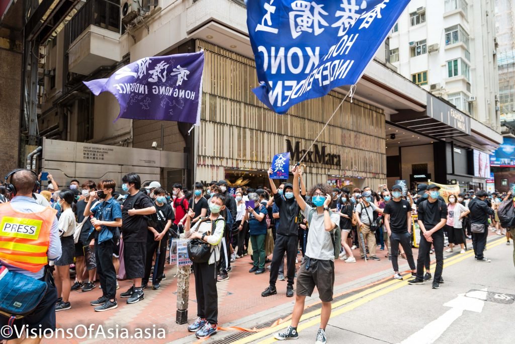Protesters wave "Hong Kong Independence" flags