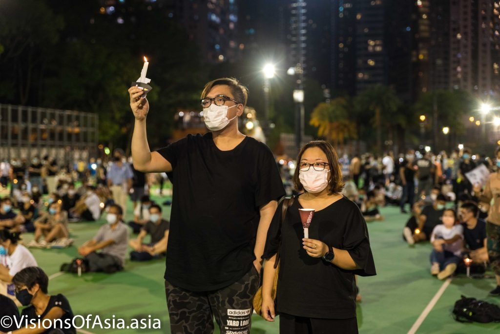 A couple holds candles in Victoria park