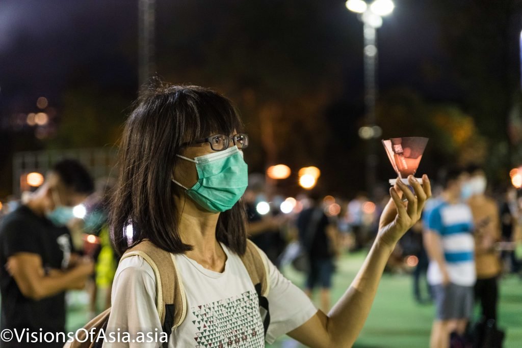 A young lady holds a candle