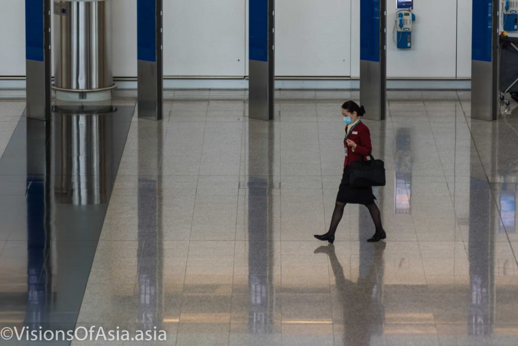 Hong Kong airport, ground staff passes through the arrival hall