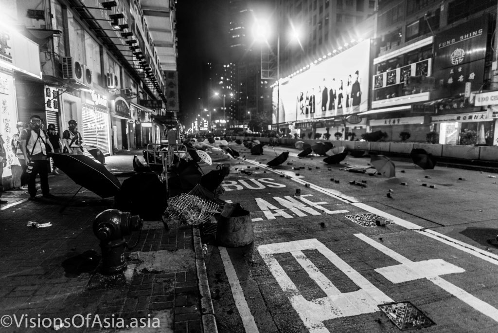 A deserted battlefield strewn with umbrellas