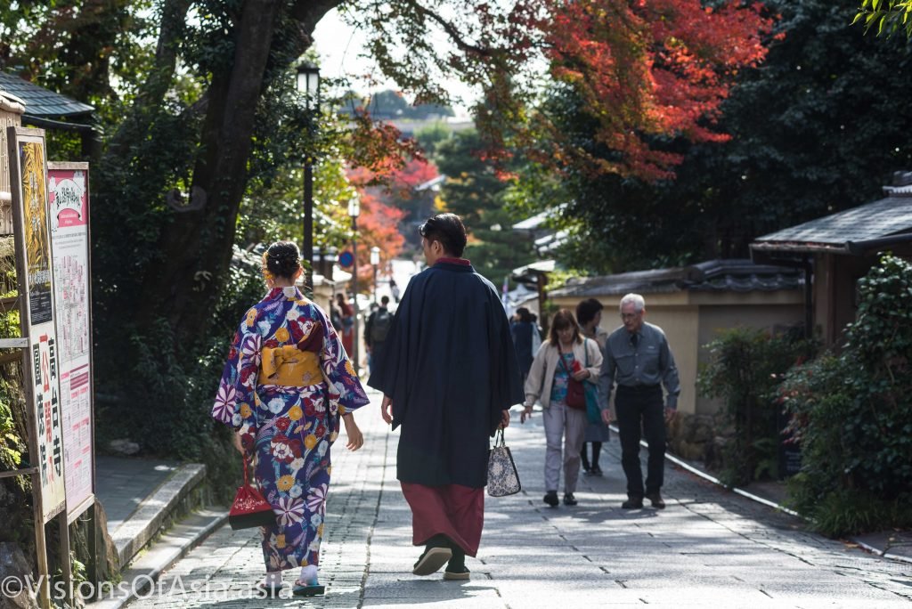 A couple walks through old Kyoto