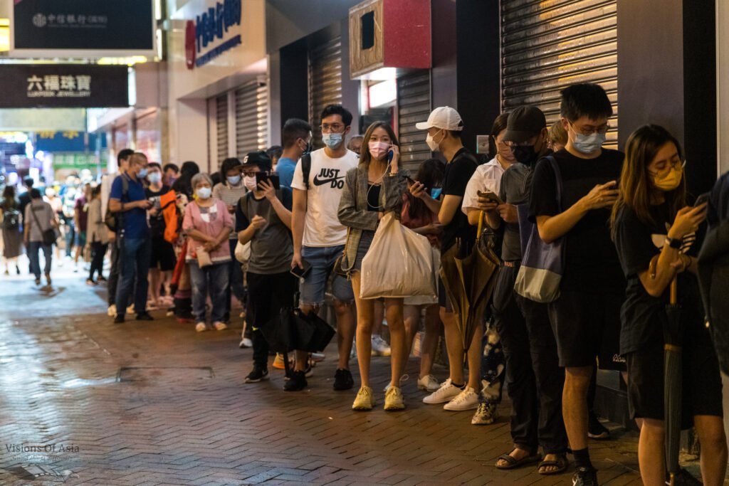 Hongkongers queue up around a block in Mongkok to make sure they can purchase one copy of the last edition of Apple Daily.