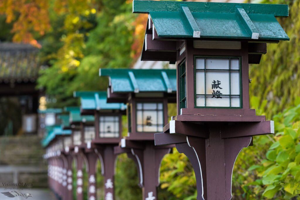 Japanese lanterns line up a side of a temple