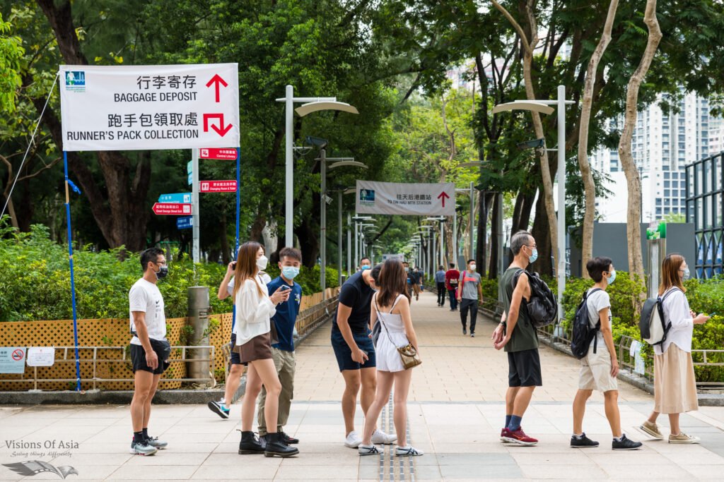 Competitors for the Hong Kong marathon line up to pick their race kit and under Covid-19 tests. The race is only open to vaccinated runners and numbers were slashed compared to the pre-pandemic situation.