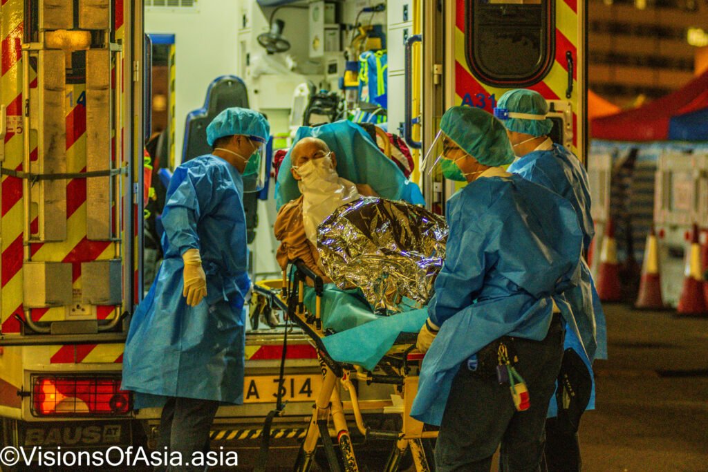 Hong Kong, 16 Mar 2022, An elderly patient is transferred out of an ambulance by paramedics at Princess Margaret hospital.