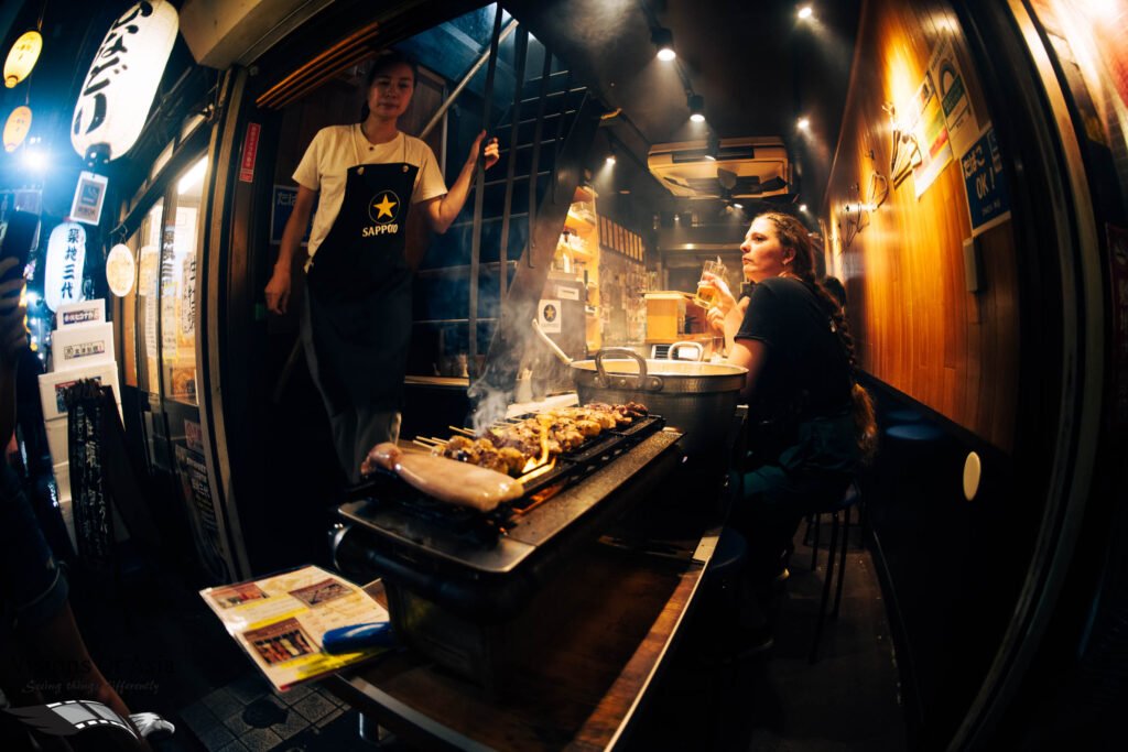 Meat is grilled on a charcoal stove in Omoide Yokocho, in Shinjuku.