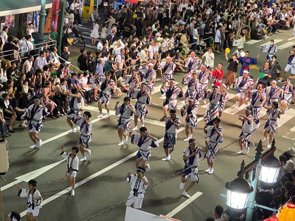 Beautiful dancers move synchronously in the streets of Tokushima.