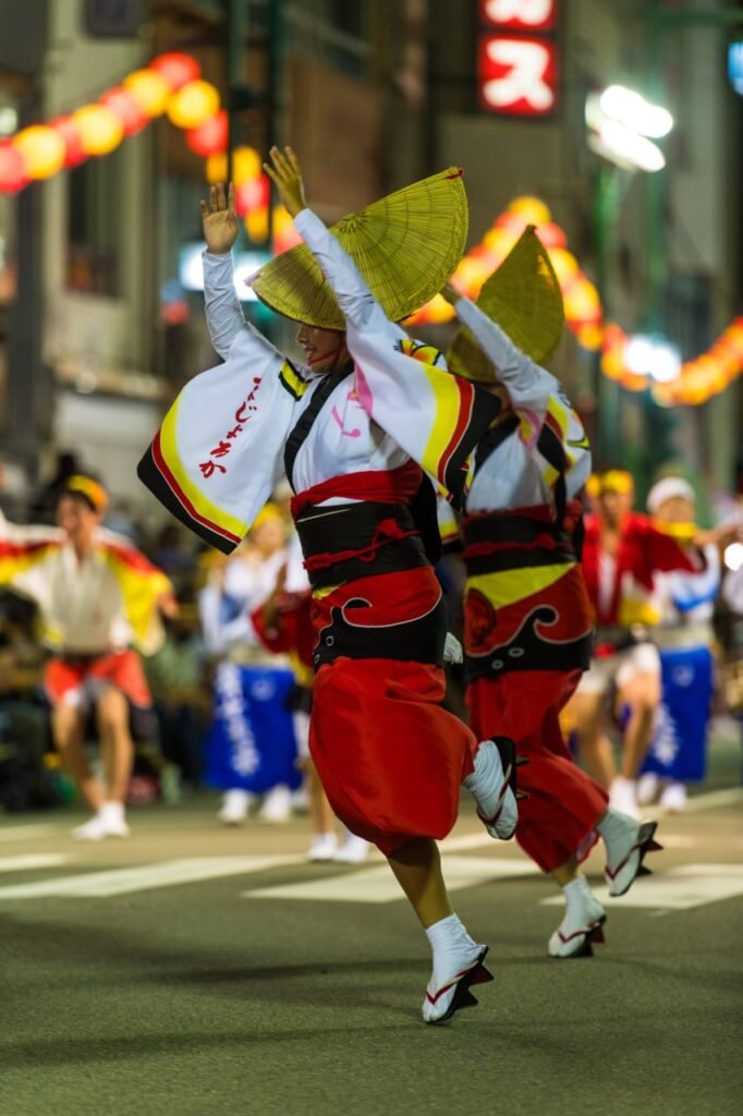 Dancers leap into the airs while performing.